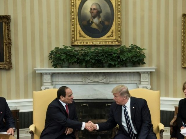 Translators watch as Egypt's President Abdel Fattah al-Sisi (L) and US President Donald Tr