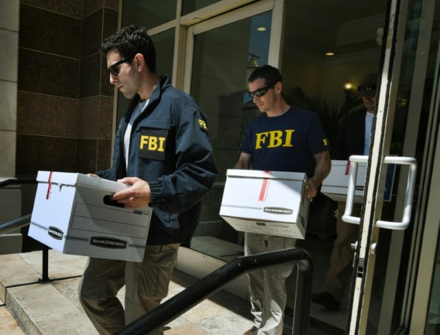 FBI agents remove documents from the offices of the California Investment Immigration Fund