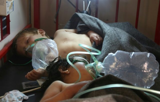 Syrian children receive treatment in the town of Maaret al-Noman, following a suspected ch