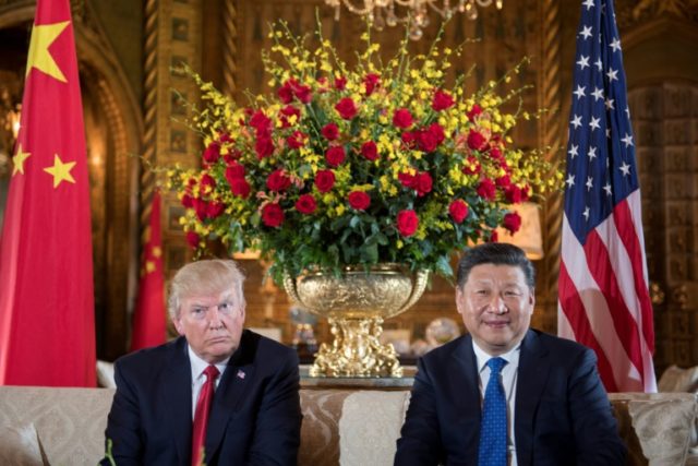 US President Donald Trump (L) sits with Chinese President Xi Jinping (R) during a bilatera