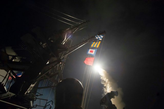 In this image released by the US Navy, the USS Ross based in the Mediterranean fires a Tom
