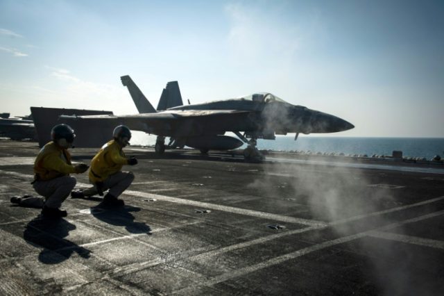 A F/A-18E Super Hornet launches from the flight deck of the Nimitz-class aircraft carrier