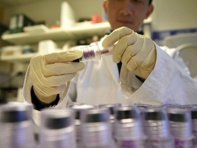 A technician holds blood samples for testing in an anti-doping laboratory