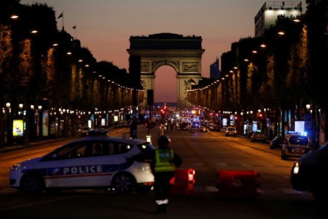 Police officers block the access to the Champs Elysees in Paris after a shooting on April