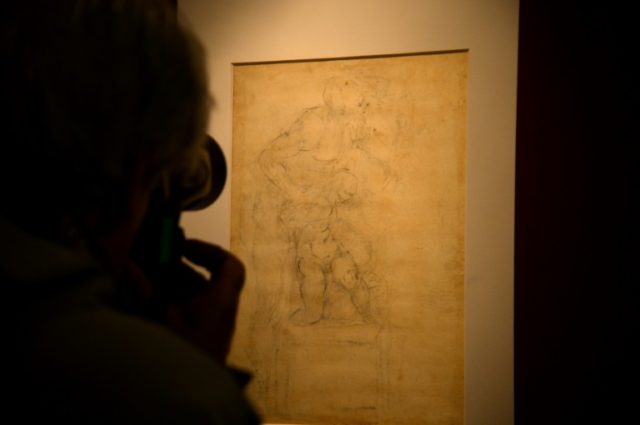 Visitors look at Michelangelo Buonarroti's drawing on paper in black pencil, red pencil an