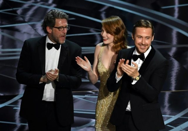 (L-R) Producer Gary Gilbert, actors Emma Stone and Ryan Gosling celebrate 'La La Land' win