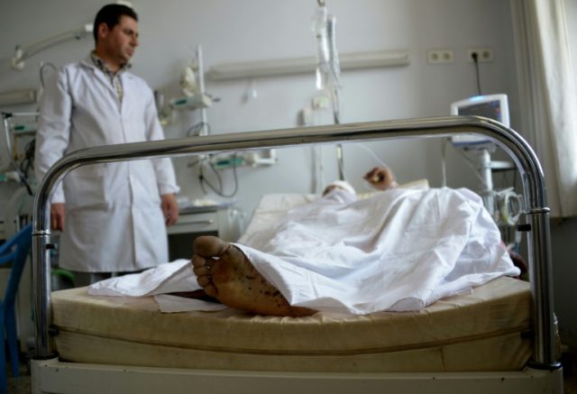 A wounded Afghan soldier lies in hospital in Mazar-i-Sharif on April 22, 2017, as he recei