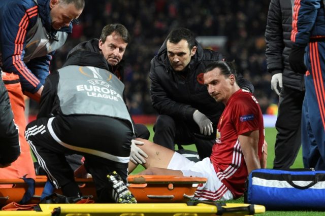 Manchester United's striker Zlatan Ibrahimovic gets treatment after injuring his knee on A