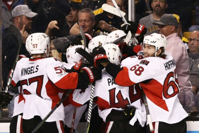 Members of the Ottawa Senators celebrate with Clarke MacArthur after he scored the game wi