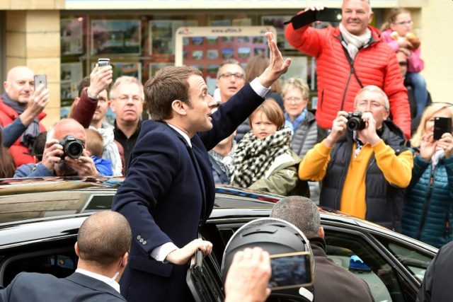French centrist presidential candidate Emmanuel Macron greets supporters as France votes i