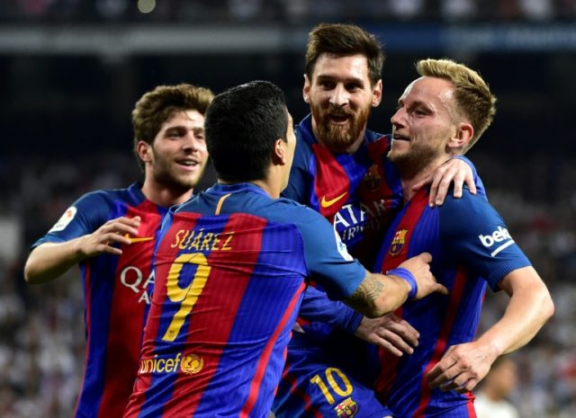 Barcelona's midfielder Ivan Rakitic (R) celebrates a goal with Lionel Messi (2ndR) and Lui