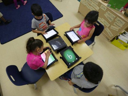 FILE - In this April 2, 2014 file photo, Pre-K students use electronic tablets at the South Education Center in San Antonio. As Gov. Rick Perry wraps up a record 14 years on the job, Republican Greg Abbott and Democrat Wendy Davis are both vowing to make public schools a …