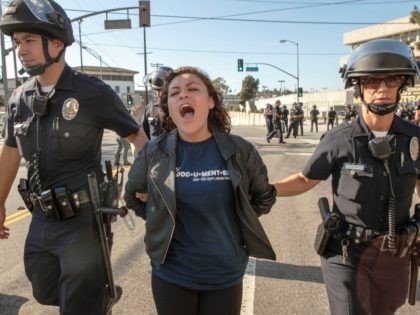 High school student Claudia Rueda, 17, center, is arrested by Los Angeles Police officers