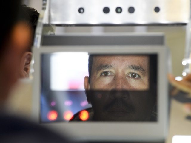 A pedestrian crossing from Mexico into the United States at the Otay Mesa port of entry has his facial features and eyes scanned at a biometric kiosk Thursday, Dec. 10, 2015, in San Diego. On Thursday, U.S. Customs and Border Protection began capturing facial and eye scans of foreigners entering …