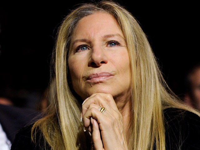 FILE - In a Wednesday, May 7, 2014 file photo, Barbra Streisand listens to President Barack Obama speak at the USC Shoah Foundation’s 20th anniversary Ambassadors for Humanity gala in Los Angeles. Streisand's husband, James Brolin, sits at left. Publisher Taschen announced Wednesday, Sept. 3, 2014, that "Barbra: Streisand's Early …