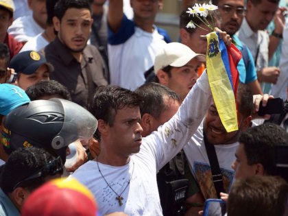 Leopoldo Lopez, an ardent opponent of Venezuela's socialist government facing an arrest warrant after President Nicolas Maduro ordered his arrest on charges of homicide and inciting violence, is escorted by the National Guard after turning himself in, during a demonstration in Caracas on February 18, 2014. Fugitive Venezuelan opposition leader …