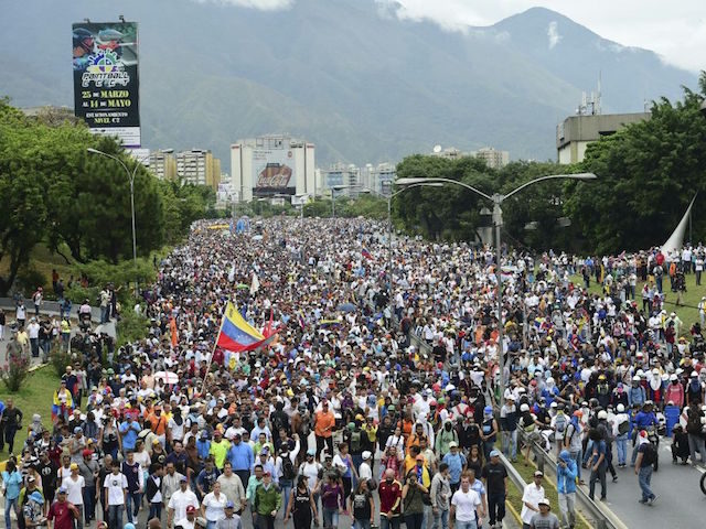 Demonstrators march along Francisco Fajardo highway in Caracas during a protest against Venezuelan President Nicolas Maduro, on May 3, 2017. Venezuela's angry opposition rallied Wednesday vowing huge street protests against President Nicolas Maduro's plan to rewrite the constitution and accusing him of dodging elections to cling to power despite deadly …