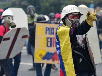 Demonstrators clash with police as they march during a protest against Venezuelan Presiden