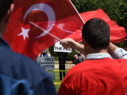 Pro-Erdogan supporters wave Turkish flags at anti government protesters in front of the White House in Washington,DC on May 16, 2017. Presidents Donald Trump and Recep Tayyip Erdogan stood side by side at the White House on Tuesday and promised to work through strained ties despite the Turkish leader's stern …