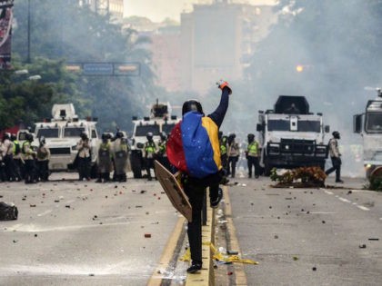 TOPSHOT - Riot police clash with demonstrators during a protest against the government of