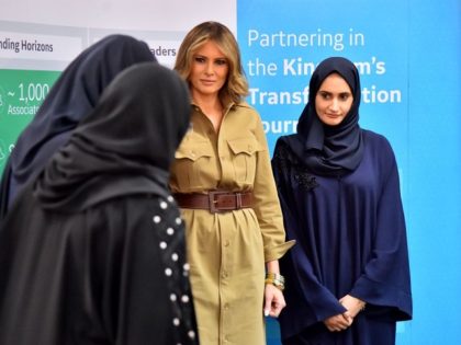 First Lady Melania Trump (C) poses for a picture with employees during a visit to the GE A