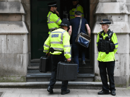Police officers carry cases into Granby House following a raid, close to Manchester Piccadilly railway station in Manchester, on May 24, 2017, as their investigations continue into the May 22 terror attack at the Manchester Arena.