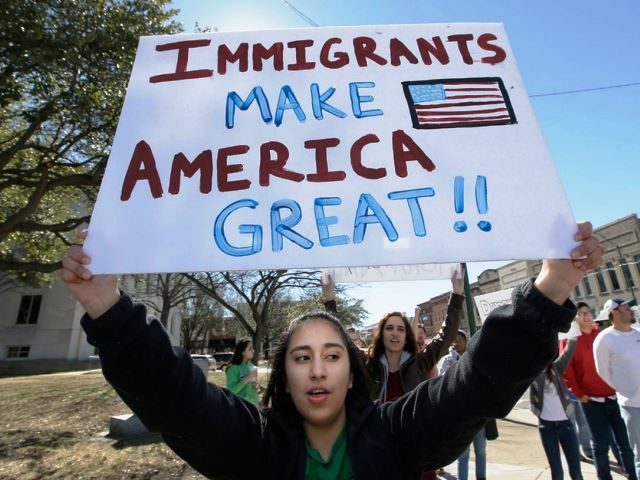 Immigrants with Immigrants Make America Great sign