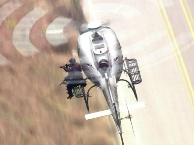 Video has emerged of LAPD Swat officers shooting from a helicopter and killing an armed ho