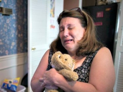 In this Wednesday, Sept. 2, 2015, photo, Dorothy McIntosh Shuemake, mother of Alison Shuemake who died of a suspected heroin overdose, cries as she clutches her daughter's toy stuffed rabbit during an interview at her home, in Middletown, Ohio. The Centers for Disease Control and Prevention has called heroin use …