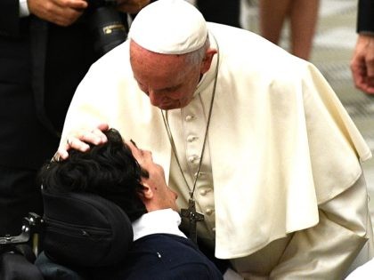 Pope Francis embraces a member of the congregation after an audience for Huntingtons disease sufferers and their families, on May 18, 2017 in the Paul VI hall at the Vatican. / AFP PHOTO / Vincenzo PINTO (Photo credit should read VINCENZO PINTO/AFP/Getty Images)