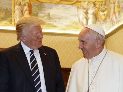 Pope Francis (R) exchanges gifts with US President Donald Trump and US First Lady Melania