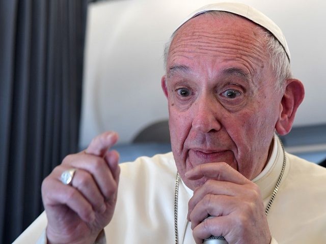 Pope Francis addresses journalists during the traditional press confernce on his flight ba