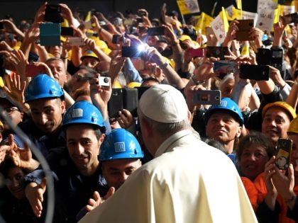 TOPSHOT - Pope Francis is welcomed and photographed upon his arrival for a meeting with workers of the Ilva steel plant as part of a one-day visit in Genoa, on May 27, 2017. / AFP PHOTO / Andreas SOLARO (Photo credit should read ANDREAS SOLARO/AFP/Getty Images)