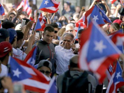 FILE - In this May 18, 2017 file photo, Puerto Rican nationalist Oscar Lopez Rivera, center, who pardoned by former President Barack Obama in January, arrives for a gathering in his honor in Chicago's Humboldt Park neighborhood. Organizers of New York's Puerto Rican Day Parade on June 11 stand firm …