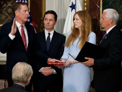 Vice President Mike Pence administers the oath of office to U.S. Trade Representative Robert Lighthizer, Monday, May 15, 2017, in the Eisenhower Executive Office Building on the White House complex in Washington. From left are, Lighthizer, Robert Lighthizer Jr., Claire Lighthizer, and Pence. (AP Photo/Evan Vucci)