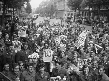 "American servicemen and women gather in front of 'Rainbow Corner' Red Cross club in Paris to celebrate the unconditional surrender of the Japanese" By McNulty, August 15, 1945 (Source: National Archives)