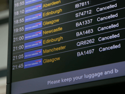 An electronic board shows British Airways flights cancelled at Heathrow Airport Terminal 5