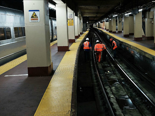 NEW YORK, NY - APRIL 26: Track maintenance workers walk along train tracks used by both Ne