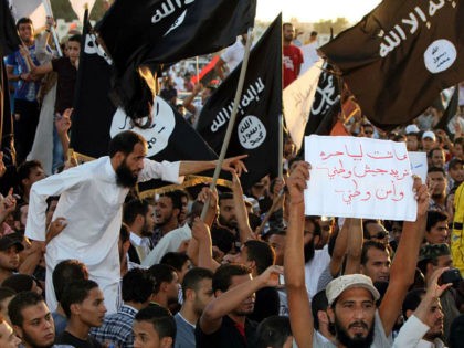 Supporters of the Jihadist group Ansar al-Sharia shout religious slogans while holding Al-Qaeda-affiliated flags to counter a demonstration by thousands of people against militias in the eastern city of Benghazi on September 21, 2012. Thousands of Libyans rallied against militias in the tense city of Benghazi, drowning out a protest …