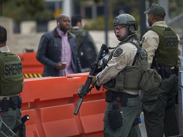 LOS ANGELES, CA - DECEMBER 06: Los Angeles County Sheriff's deputies stand guard over rail