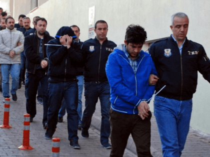 Police officers escort people, arrested because of suspected links to U.S.-based cleric Fethullah Gulen, in Kayseri, Turkey, Wednesday, April 26, 2017. Police launched simultaneous operations across the country on Wednesday, detaining hundreds of people with suspected links to U.S.-based cleric Fethullah Gulen. The suspects are allegedly Gulen operatives who directed …