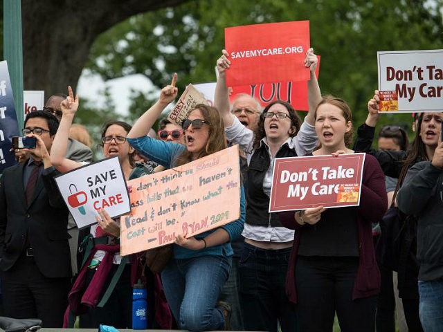 Protesters hold signs and shout at lawmakers walking out of the US Capitol in Washington, DC, on May 4, 2017 after the House of Representatives narrowly passed a Republican effort to repeal and replace Obamacare, delivering a welcome victory to President Donald Trump after early legislative stumbles. Following weeks of …