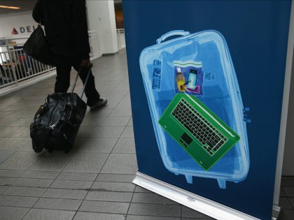 NEW YORK, NY - JANUARY 27: A traveler walks past a newly-opened TSA Pre-check application center at Terminal C of the LaGuardia Airport on January 27, 2014 in New York City. Once approved, travelers can use special expidited Precheck security lanes. They can also leave on their shoes, light outerwear …