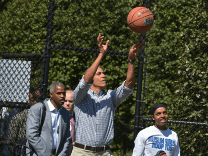 Then-US President Barack Obama takes a shot while playing basketball during the annual Easter Egg Roll on the South Lawn of the White House on April 6, 2015 in Washington, DC