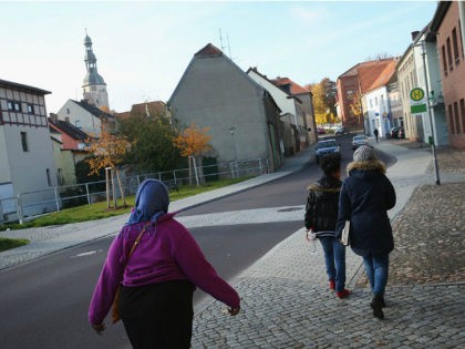 BAD BELZIG, GERMANY - OCTOBER 26: Warda Abdi (R), 23, an asylum-seeker from Somalia, walks with her friends and fellow-asylum seekers Asha (L), from Somalia, and Biti, from Eritrea, in the town center on October 26, 2015 in Bad Belzig, Germany. Warda lives in a shelter for asylum-applicants in Bad …