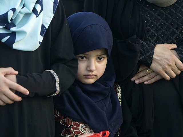 A Palestinian girl attends the morning Eid al-Fitr prayers in Gaza city on July 6, 2016. Muslims worldwide celebrate Eid al-Fitr marking the end of the fasting month of Ramadan. / AFP / MAHMUD HAMS (Photo credit should read MAHMUD HAMS/AFP/Getty Images)