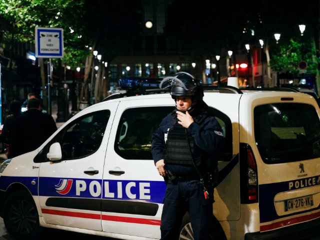 A French Police officer stands guard in front of the North station in Paris, on late May 8