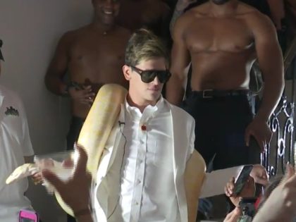 Milo Yiannopoulos speaks while draped in a snake