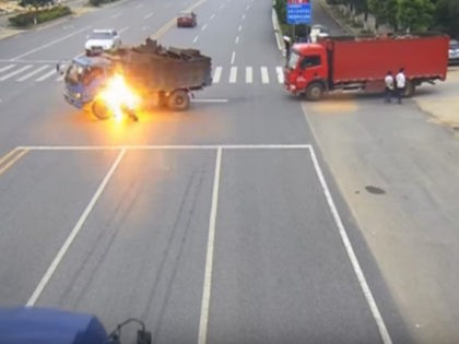 A motorcyclist in China survived a crash Saturday in which his motorcycle burst into flames. He was rescued, thanks to a truck driver’s quick thinking.