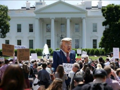 WASHINGTON, DC - MAY 10: A demonstrator wears a large effigy of President Donald Trump during a protest rally against President Donald Trump's firing of Federal Bureau of Investigation Director James Comey outside the White House May 10, 2017 in Washington, DC. Angry over the firing of Comey, about 300 …